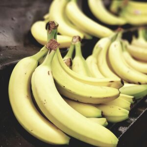 Close-up shot of vibrant yellow bananas on display, highlighting freshness and nutrition.