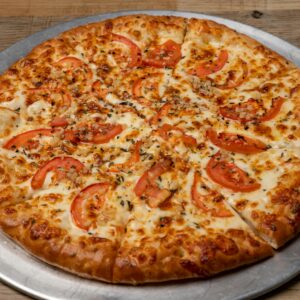 Savor a freshly baked Margherita pizza topped with ripe tomatoes and melted mozzarella cheese.